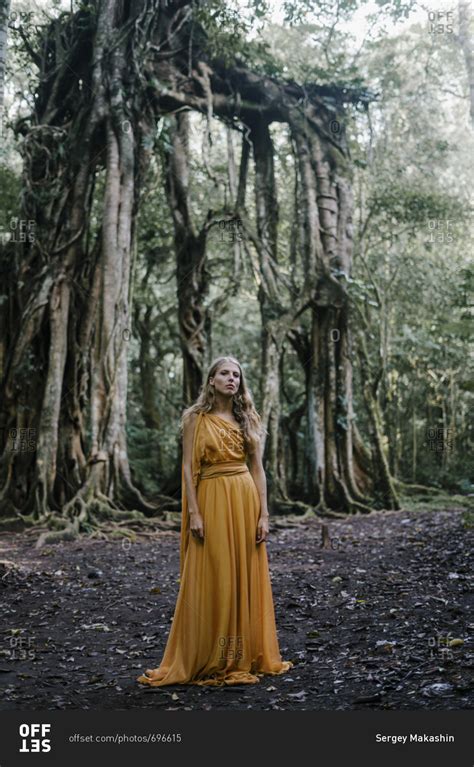 Blonde Woman Wearing Golden Gown By Banyan Trees Stock Photo OFFSET