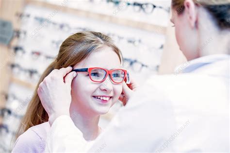 Optometrist Trying Glasses On Girl Stock Image F018 2839 Science Photo Library