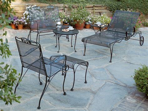 Gorgeous Patio Design Using Black Wrought Iron Chair And Round Table By