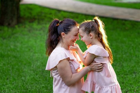 Premium Photo Happy Mother And Daughter 5 6 Years Old Walk In The Park In The Summer Mother