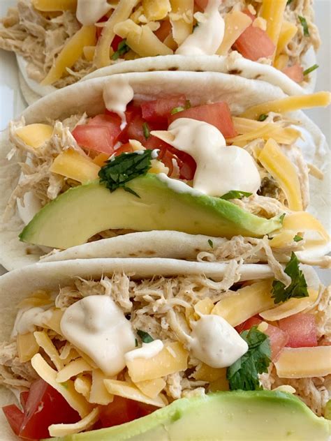 Let the slow cooker do all the work with this easy keto slow cooker shredded chicken taco recipe! Slow Cooker Queso Chicken Tacos | Together as Family