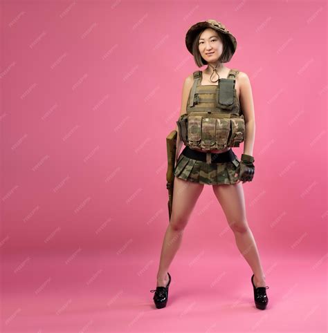 Premium Photo Sexy Asian Woman In Military Clothes With An Automatic Rifle In Her Hands While