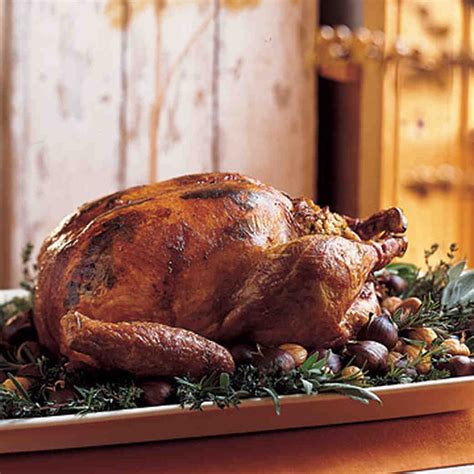 The Turkey Is Roasted With Parsley And Sage Leaves Tucked Under Its
