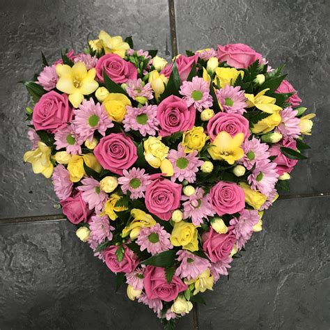 Yellow And Pink Loose Filled Heart Funeral Tribute With Roses Freesias
