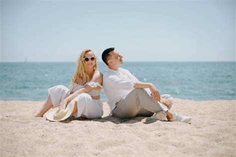 Lovers Siting Looking Into Sky And Ocean Mountion Under Sun Vacation Tourism Hooneymoon