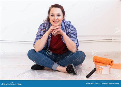 Cheerful Woman Painting The Walls Of New Home Renovation Repair And