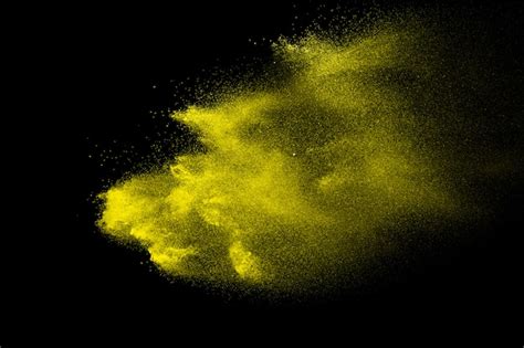 Premium Photo Yellow Powder Explosion In The Dark