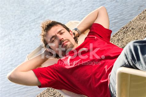 Guy Lying By The Water Stock Photo Royalty Free Freeimages
