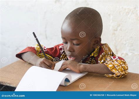 Handsome Young African Boy Writing And Learning In School Building