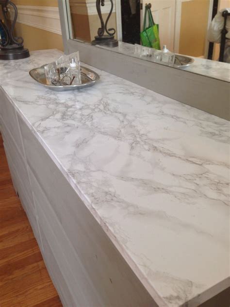 But did you know that you can do the same thing to your entire kitchen counter? Faux marble contact paper covers damaged dresser top ...