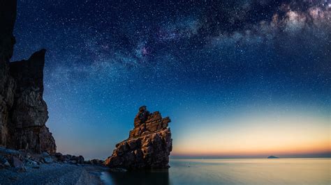 Starry Night Over Rock Formations By The Pacific Ocean Dalian