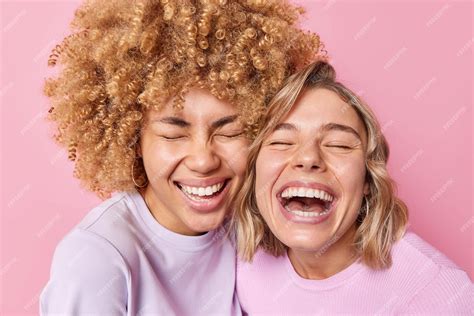 Free Photo Two Overjoyed Young Women Laugh Out Gladfully Keep Eyes Closed Stand Closely To