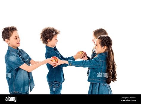 Four Children In Denim Clothes Holding Apples Isolated On White Stock