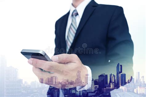 Double Exposure Businessman Using Smartphone With City View Background