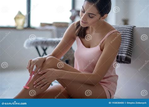 Woman Shaving Her Legs And Looking Involved Stock Photo Image Of