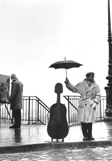 Robert Doisneau Musician In The Rain Paris 1957 Uselessmuseum