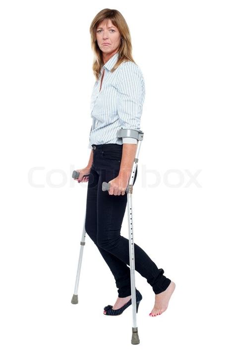 Pensive Looking Woman Using Crutches To Walk Stock Photo Colourbox