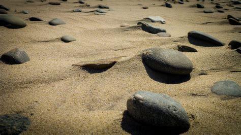 Closeup Photography Of Assorted Stones On Brown Sand · Free Stock Photo