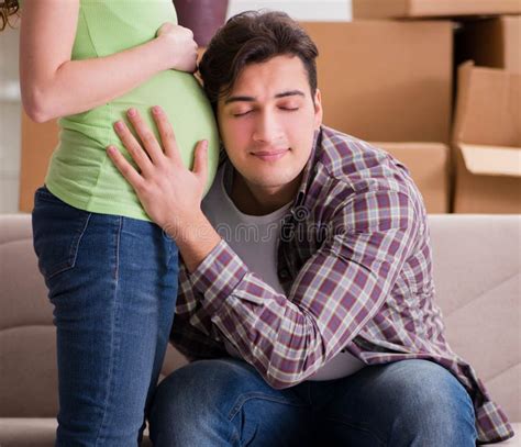 Young Couple Of Man And Pregnant Wife Expecting Baby Stock Image