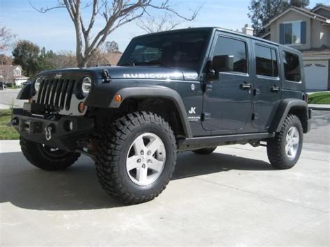 a black jeep parked in front of a house