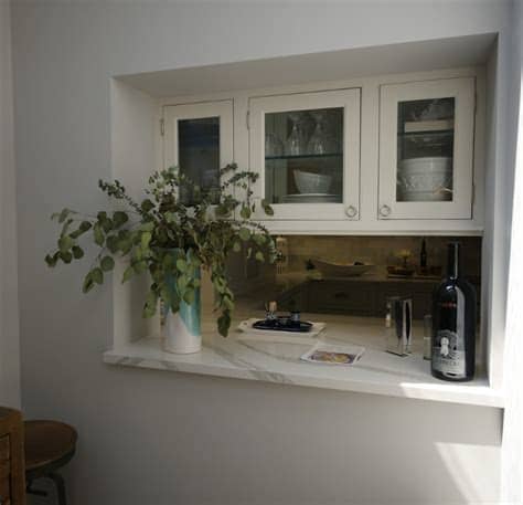 Not only do they break up the monotony of repetitive, solid cabinet faces—glass doors add both form and functional appeal. White Kitchen with Driftwood Peninsula - Home Bunch ...