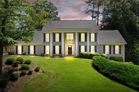 Many times the sticking point on an older 1950s to 1990s house is ugly brick. Beautiful white painted brick home for sale in Roswell GA. Large front porch with pillars, til ...