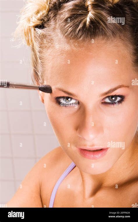 Portrait Of A Young Woman Applying Eyeshadow Stock Photo Alamy