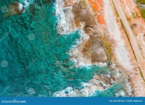 Overhead View Of Turquoise Sea Waves And A Rocky Shoreline Stock Photo