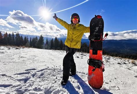 A Woman Standing On Top Of A Snow Covered Slope Stock Photo Image Of