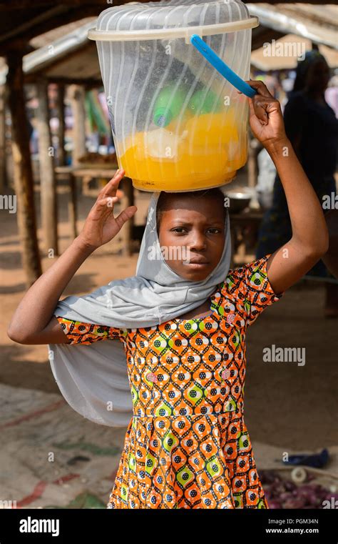 bohicon benin jan 12 2017 unidentified beninese woman carries a bucket on her head at the