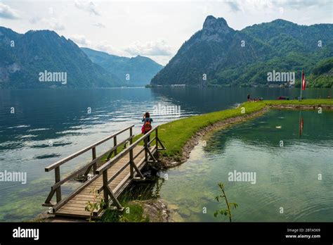 Tourist Taking Picture Of The Stunning Mountain Scenery At The Traunsee