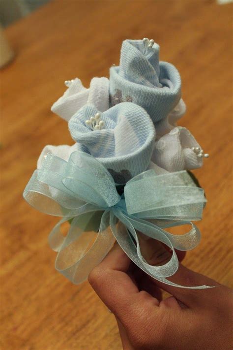 You can choose either fresh or silk flowers or you can make a bouquet out of baby socks. : How To: Baby Sock Corsage | Baby sock corsage, Baby shower corsage, Baby shower coursage