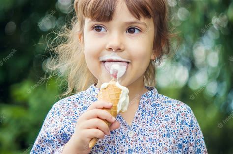 Premium Photo The Child Eats Ice Cream Selective Focus