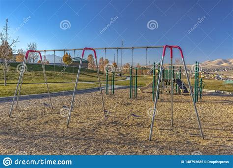Swings Climbing Bars And Slide At A Playground Viewed On A