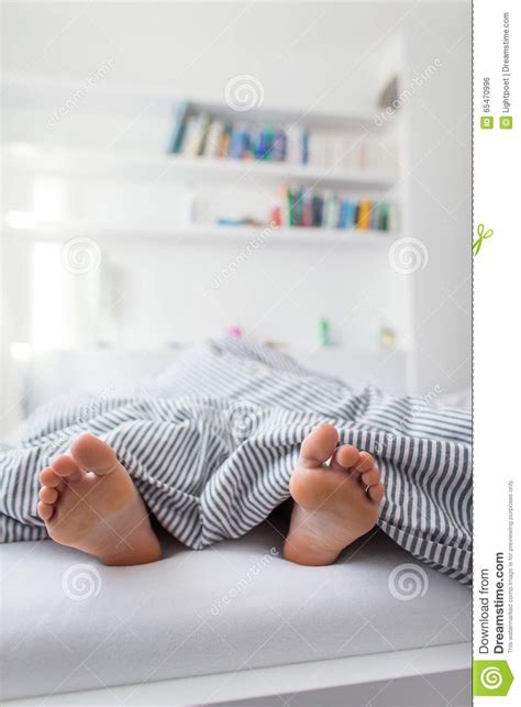 Feet Of A Person Sleeping In Bed Stock Photo Image 65470996