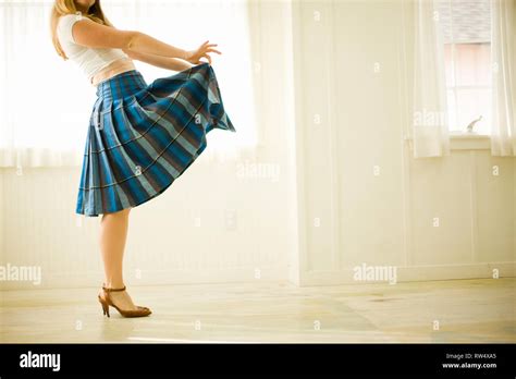 Woman Playfully Lifting Her Skirt Stock Photo Alamy