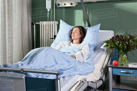A Woman Lying In A Hospital Bed Stock Photo Dissolve
