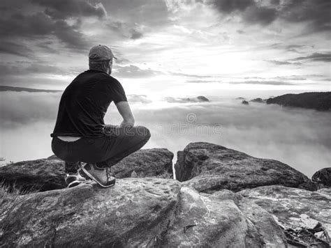 Hiker In Middle Of Nowhere And Thinking Alone Man Sit On Top Stock