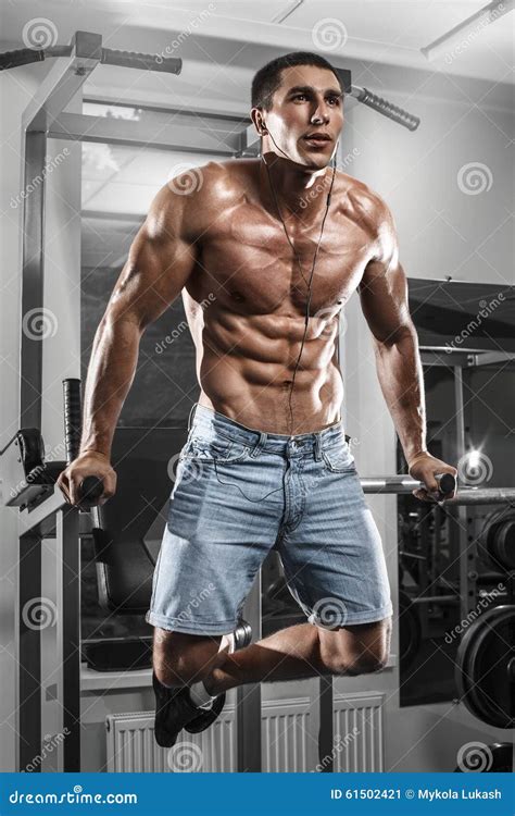 Muscular Man Working Out In Gym Doing Exercises On Parallel Bars Strong Male Naked Torso Abs