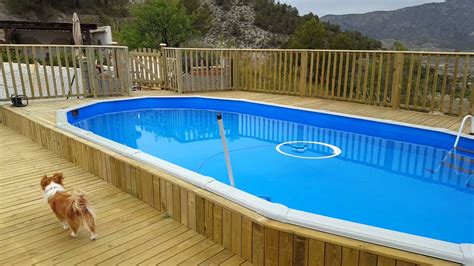 Building a deck around your pool can make it look more beautiful and give your family a place to sit and enjoy while at the pool. Above ground pool and deck build - YouTube