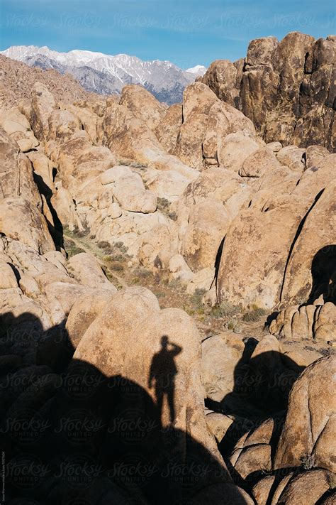 Shadow Of Man In Rocky Texture Mountainous Landscape By Stocksy