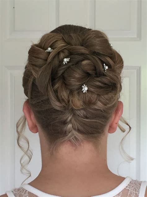 Curly bun with a French plait up the back done upside down ...