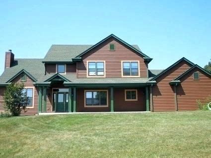 Grey old house front porch exterior with red door. Brown house with green trim | Brown house exterior, Brick ...