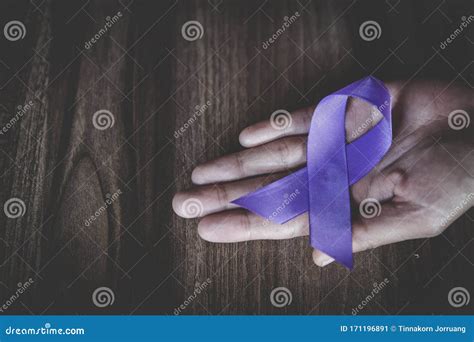 Purple Ribbon In A Woman`s Hand Domestic Violence Awareness Month