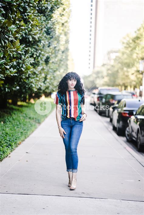 Latina Woman Walking On A Sidewalk Royalty Free Stock Image Storyblocks