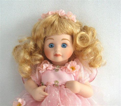 Porcelain Baby Girl Doll Curly Blonde Hair Pink Outfit Blue Eyes Delton