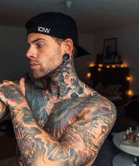 a man with tattoos on his arms and chest