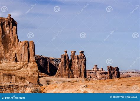 Three Sisters Rock Formation In Arches National Park Under The Sunlight