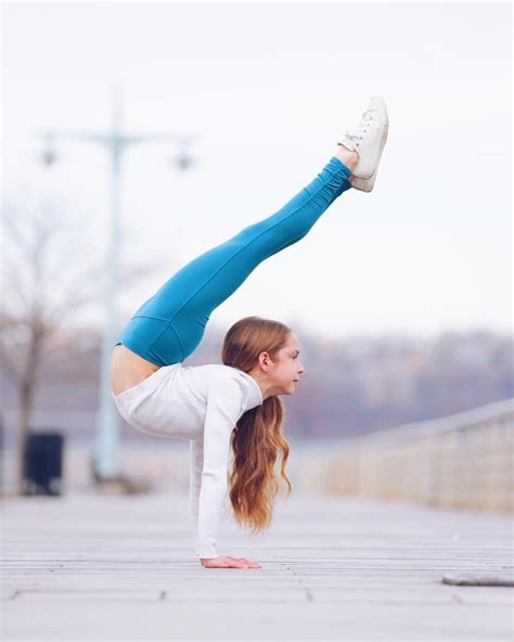 A Woman Doing A Handstand On The Ground