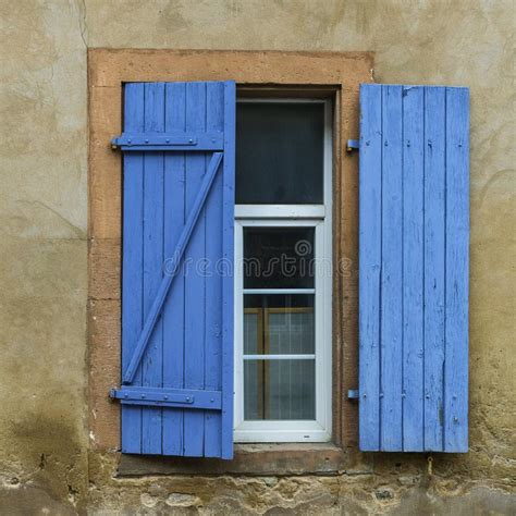Blue Weathered Wooden Shutters And A White Window Stock Photo Image